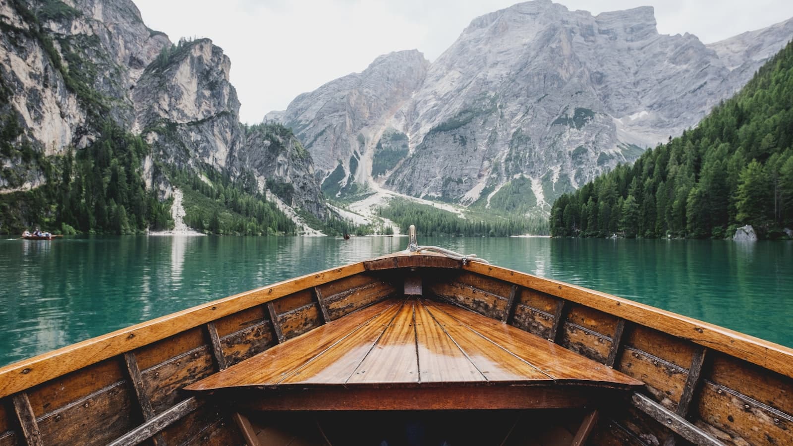 A wooden boat on a still mountain lake