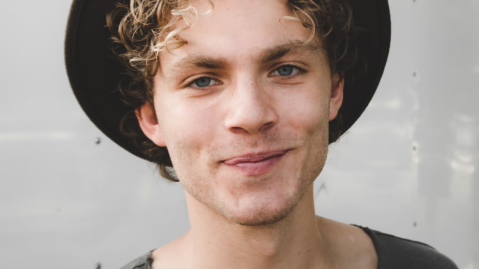 Young man in a hat smiling